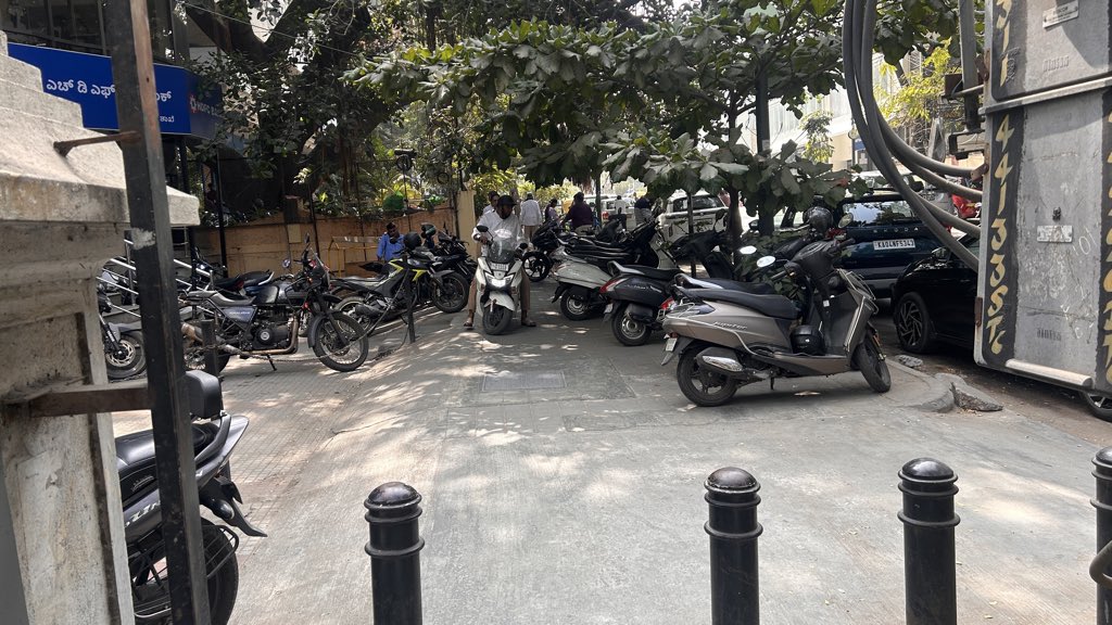 rajthesaviour's tweet photo. @highgroundtrfps  
Img of bikes parked on footpath in front of @HDFC_Bank Millers Rd. Peds can't walk; slope makes it tough for elderly. Next to @ManipalHealth Millers Rd. Pls address ASAP. https://t.co/7eLcGhvWS3