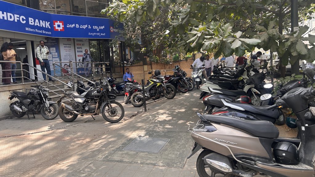 rajthesaviour's tweet photo. @highgroundtrfps  
Img of bikes parked on footpath in front of @HDFC_Bank Millers Rd. Peds can't walk; slope makes it tough for elderly. Next to @ManipalHealth Millers Rd. Pls address ASAP. https://t.co/7eLcGhvWS3