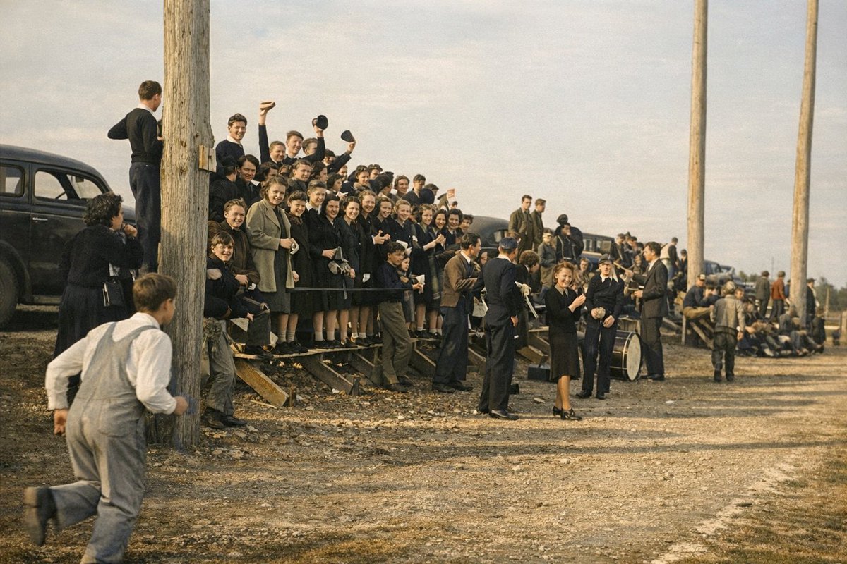 Cheering on the Wolverines… I believe at the football field where the elementary is now.