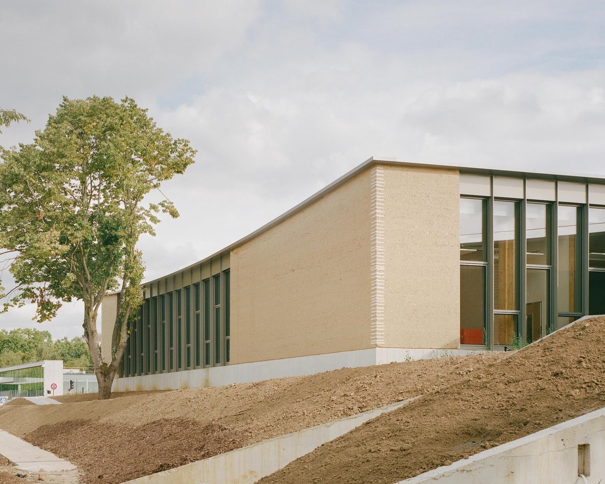 Archello's tweet image. Designed by HEMAA Architectes, the Parc des Loges Childhood and Sports Center is shaped by rammed earth and timber construction, embedding learning spaces directly into the landscape.
archello.com/project/parc-d… 

#RammedEarth #TimberArchitecture #LowCarbonDesign