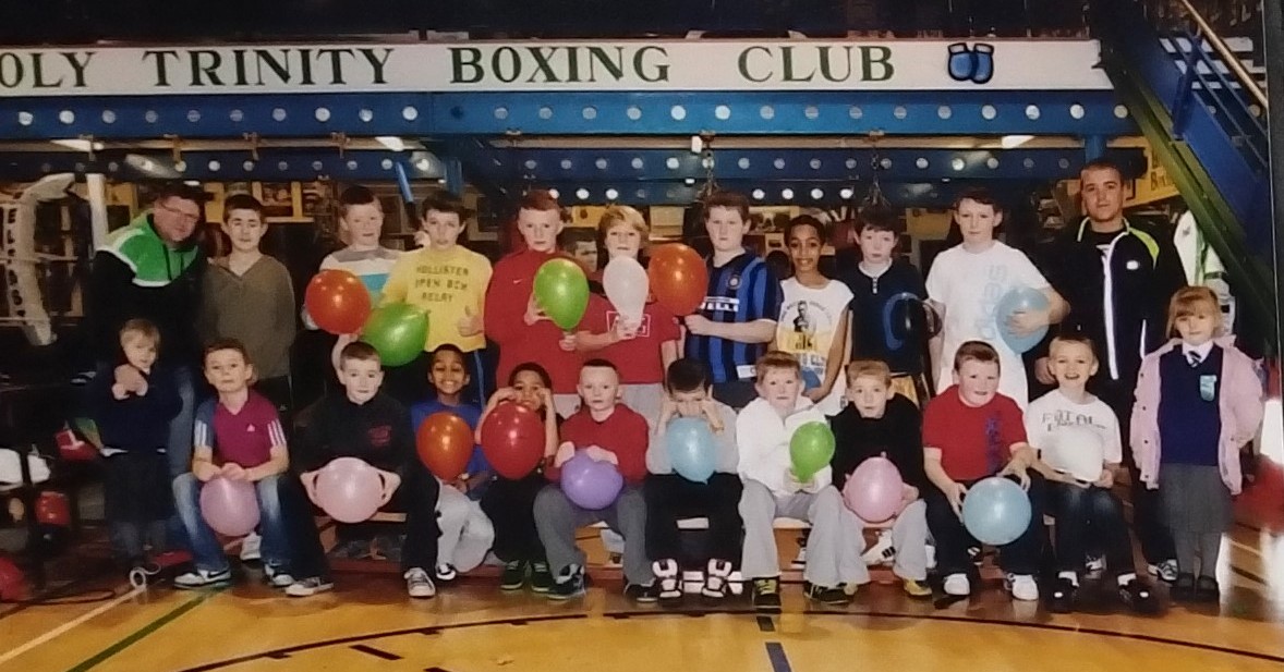 HTBC_Belfast's tweet photo. FROM THE ARCHIVE: a welcome break from training for this bright young Holy Trinity squad back in the day. Coaches Paul Shaw (left) and Peter Brady Jnr (right) with the club's Junior squad at an end-of-year party in the Turf Lodge gym around 2013.
#TeamHT https://t.co/U1Z2FSSW8J