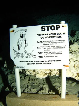 IRLAnomaly's tweet image. An eerie underwater cave death warning sign
