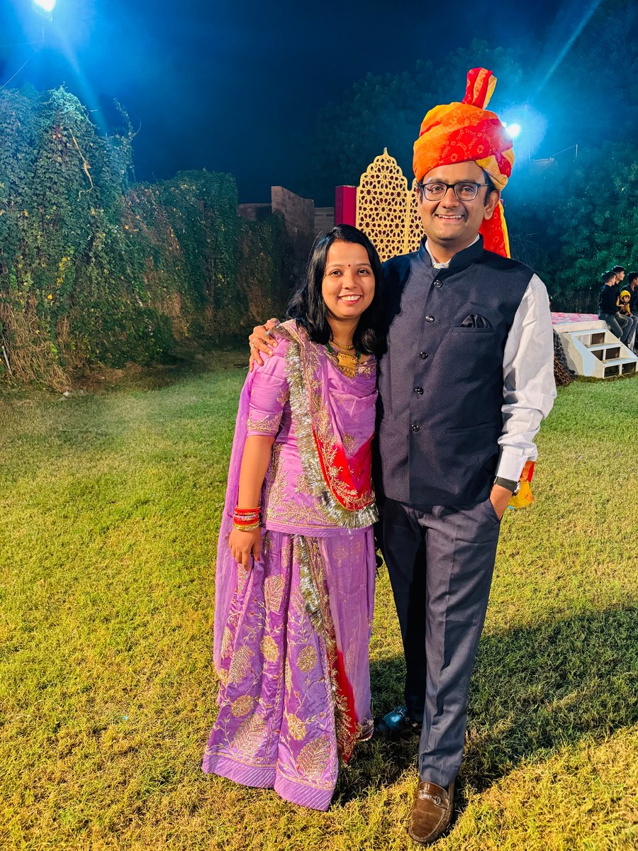 authorankit's tweet photo. @grok change the attire of the couple in photo in such a way that the couple is wearing traditional Rajasthani attire and standing in farmland and the men is having moustache https://t.co/ZXEKM60enp