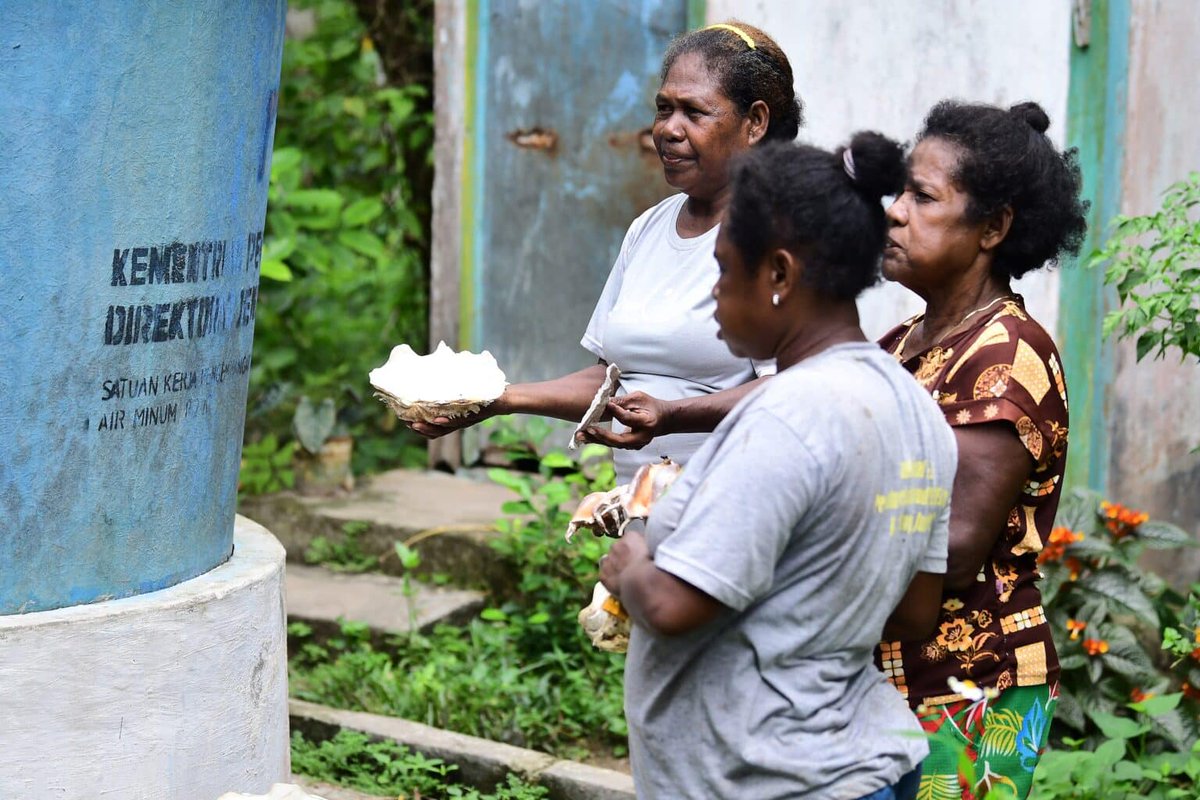 Nurhalimah Mnuari, a woman in Sombokoro, Wondama Bay, West Papua (holding clam shells) shows shells ready to be processed into lime for betel chewing. Nurhalimah, whose hair has turned white with age, still carries an unyielding spirit to provide for her family. She is also known