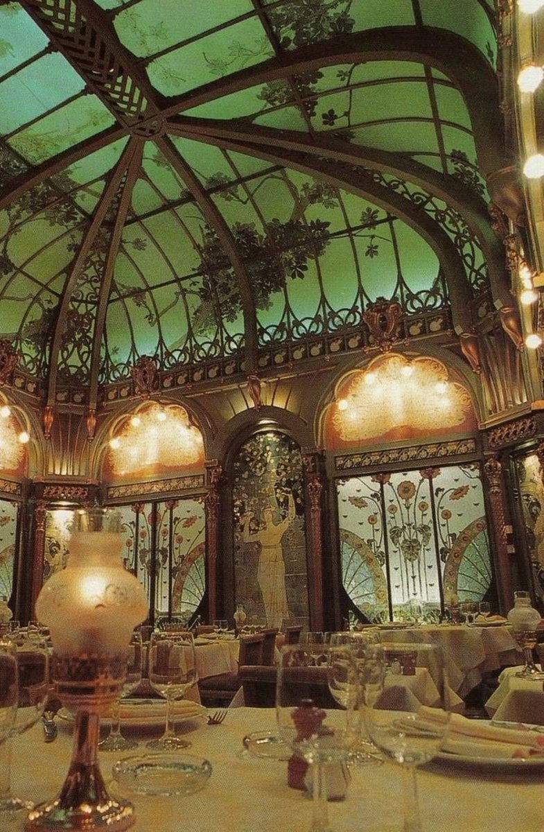 The interior of the historic La Fermette Marbeuf restaurant in Paris, renowned for its Art Nouveau style.