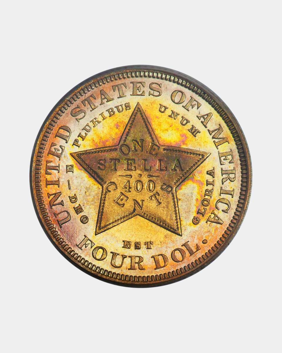 This is the reverse side of a 1879 U.S. $4 Stella pattern coin (a rare experimental gold piece also known as the “four-dollar gold coin”).
The inscriptions visible on this side are a mix of English and Latin:
Around the edge (legend):
•UNITED STATES OF AMERICA – Standard English