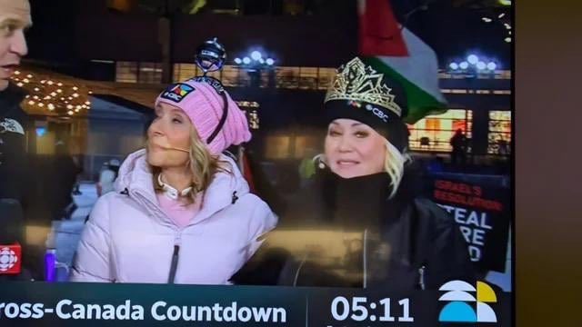 HonestRepCanada's tweet photo. Once again, @CBCNews allowed radical anti-Israel thugs to display their hateful rhetoric on screen during last night’s NYE broadcast. 

Instead of letting Canadians celebrate the New Year, our public broadcaster allowed anti-Israel propaganda to be imposed on viewers. https://t.co/bZQdHZF55R