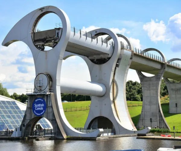 This is the Falkirk Wheel, the only rotating boat lift of its kind in the world. A combination of engineering and art allows the wheel to raise boats by more than 114 feet before they sail through the sky. Situated in central Scotland, it connects the Union Canal with the Forth