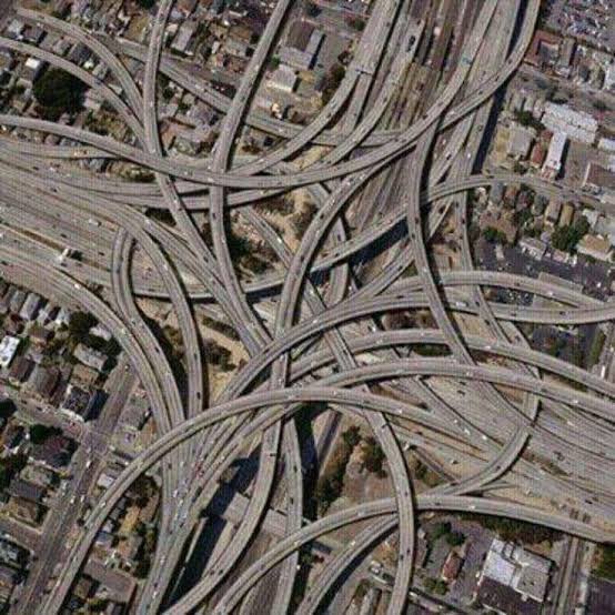 ameetgsingh's tweet photo. Traffic in Pune 

Pune now is 350 square kilometres. 
It has 2500 kilometres of road length. 
Over 7% of Pune’s surface area is roads.
It should get doubled.
PMPML has 2000 + buses.
40% of Pune’s bus capacities run empty. 

The Metro length is 32 kilometres. 
The Metro length is expected to double this year, then double again & double again. 
80% of metro capacities run empty.

Punes population is estimated to be 1 crore & expected to Double too.

Pune has 72 lakh personal vehicles. 
90% of Pune’s traffic uses 285 kilometres of Roads in Pune.

This is data from the IAS / IPS bunch. 

They keep delivering this information in their presentations again and again. They keep insisting Pune needs to double its infrastructure. Roads Double, Metro Double, Building Construction Double, Housing triple.
You get the drift…

Some of the glaring contradictions presented in the data is as follows.

They state that 80 to 85% of Pune’s traffic uses only 285 kilometres of Road length in Pune. So, if 85% of Pune’s traffic load exists on barely 11% of Pune’s roads. How does it explain the need to justify doubling Pune’s road and flyover infrastructure. They do not and when they are confronted with this glaring discrepancy a IPS officer says he is not responsible for this data but PMC is. An IAS officer says the IPS is & both say the PMPML is and so on and on.

Double Roads / Buildings / Metro = Double corruption, Double concrete, Double pollution, Double traffic, Double garbage.

But, they won’t tell you that, what they will tell you is, Pune has a comprehensive mobility plan, Public transportation should be encouraged and it should be used by 50% of the population. Metro usership is only 20% and has 80% spare capacity and PMPML usership has 40% or more spare capacity. PMPML offsets only 11% of the current demand for Public transport. This while we have 2000 buses according to the information provided to them by PMPML. Another IAS run enterprise.

Now if 85% of the traffic is on 285 kilometres of road, All it would need to ensure a bus every few minutes on 285 kilometres of road length is 285 buses.

Even if you double the number for accommodating traffic both ways it is still 570 buses. To avoid traffic people can then be encouraged to use state of the art bus transportation.

Why isn’t the route of public transportation optimized and organized to ensure app based route predictability, ticketing and seat availability on the roads which experience maximum traffic.

When faced with this question,

A IPS officer again tried to fence with me in public by saying that what PMPML does is managed by a separate IAS officer on the board of PMPML.

The PMPML website reveals that Shrimati Archana Gaikwad RTO Pune also sits on their board as a RTO representative which I believe functions in close association with the Traffic Police headed by a IPS officer  Shri Manoj Patil, but I am supposed to believe, they can’t plan routes together ? 

And then, IPS - IAS people tell us that during Diwali, from 42 lakh vehicles on Pune’s roads it came down to 32 lakh vehicles because of which we had no traffic congestion.

How did they arrive at this number ? 

There are no answers.,

The truth is, 30 million daily vehicle trips in Pune, assuming average trip length of 12 km and congested speed of 20 kmph, equates to about 750,000 vehicles on roads simultaneously across the network.

But, while presenting to us the numbers presented are 5X what they actually are. 

And these IPS IAS worthies are responsible for Pune’s traffic.

Pune is supposed to believe these lies. 

So many contradictions presented by them to us and the people of Pune have to live with broken down traffic infrastructure and gerrymandered data. That isn’t the point, the more important point is that these officers who claim to know what they talk about are actually peddling fake narratives.

“Lies are Convenient”

This is why,
Pune will suffer traffic.

Image 1 our present
Image 2 future promise,