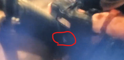 Everyone is laughing at this. She's just pressing the bolt catch. That's her thumb. 

I don't know who this is or what show/movie it's from.