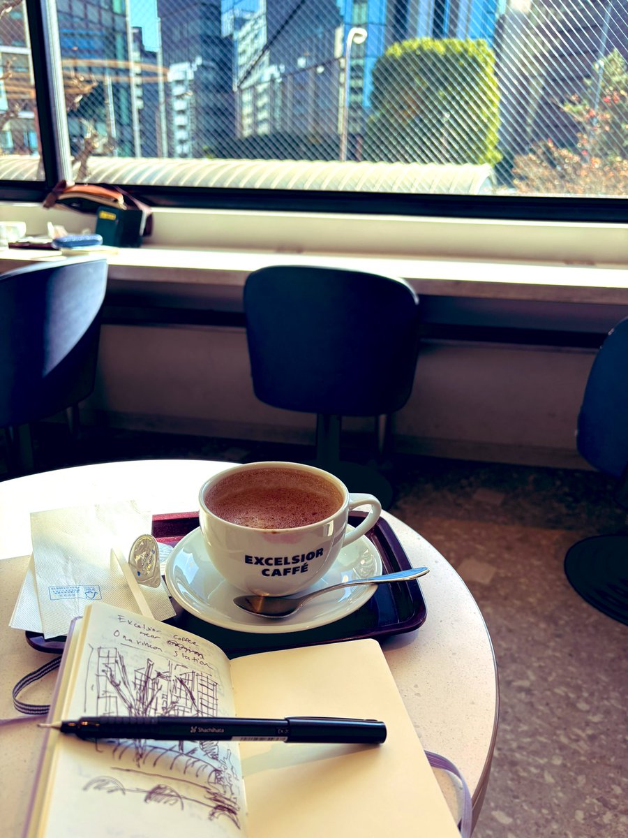 In a coffee shop drawing an intersection in Minato City, sipping my mocha. They’re playing city-pop soft jazz. My sweater still smells faintly of incense from the temple. I sort of consider I may have died? And this is Coffeecore  Heaven?