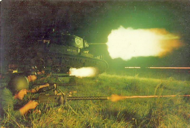 A Brazilian M3A1 Stuart tank and soldiers with M1919 machine guns during a night exercise, late 1960s.