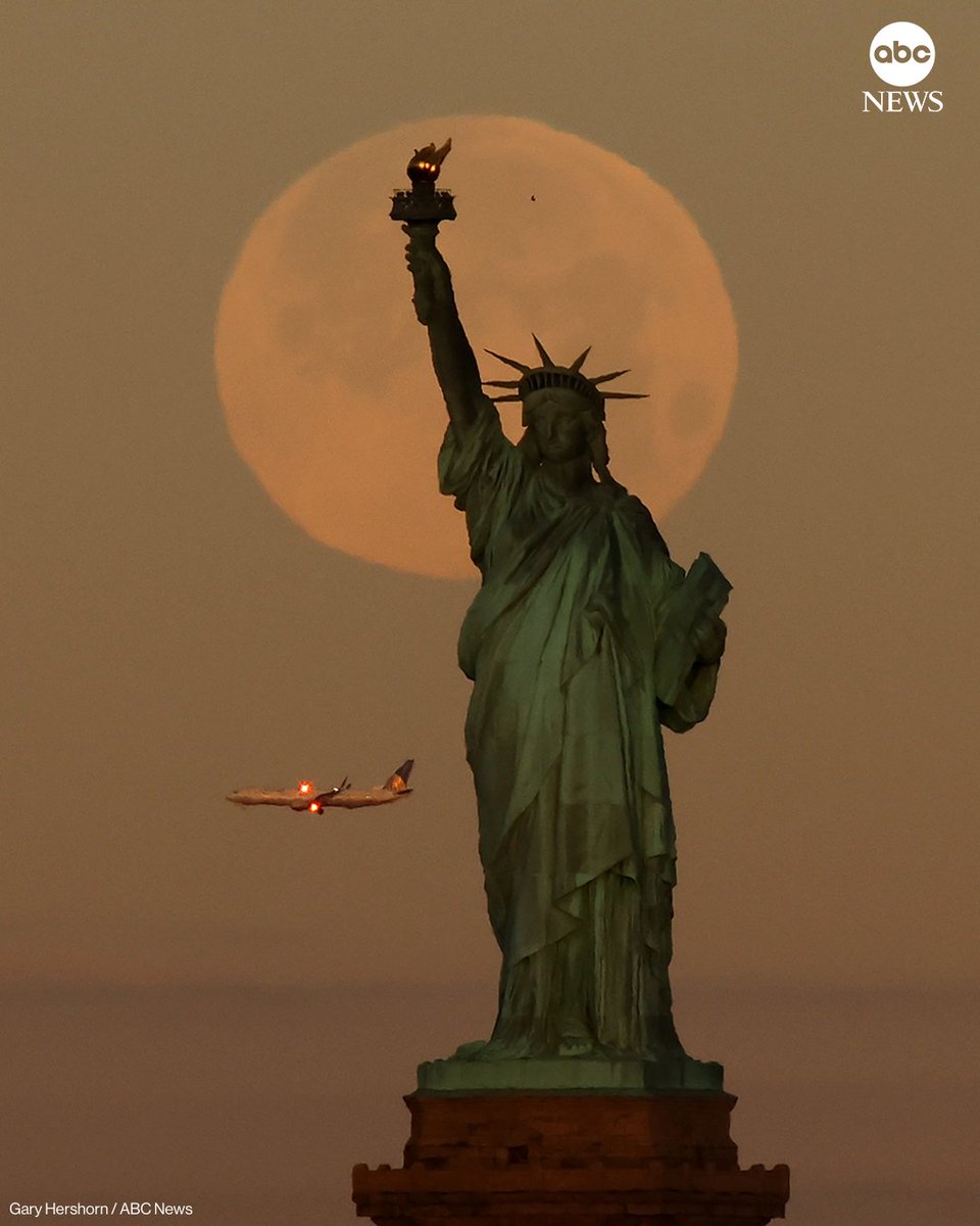 ABC's tweet image. The full Wolf Moon supermoon sets behind the Statue of Liberty as the sun rises on Saturday, in New York City. abcnews.link/6uhooY2