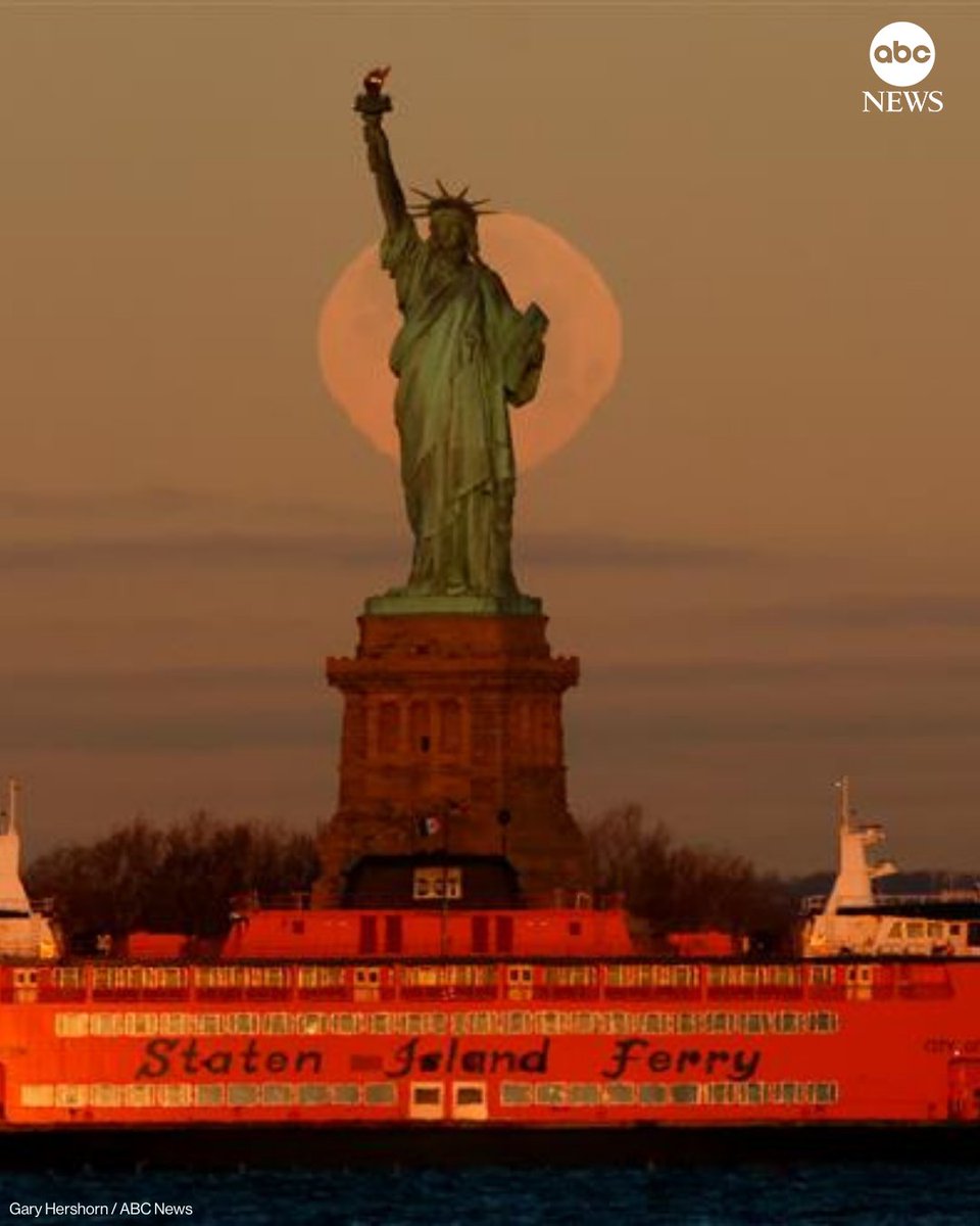 ABC's tweet image. The full Wolf Moon supermoon sets behind the Statue of Liberty as the sun rises on Saturday, in New York City. abcnews.link/6uhooY2
