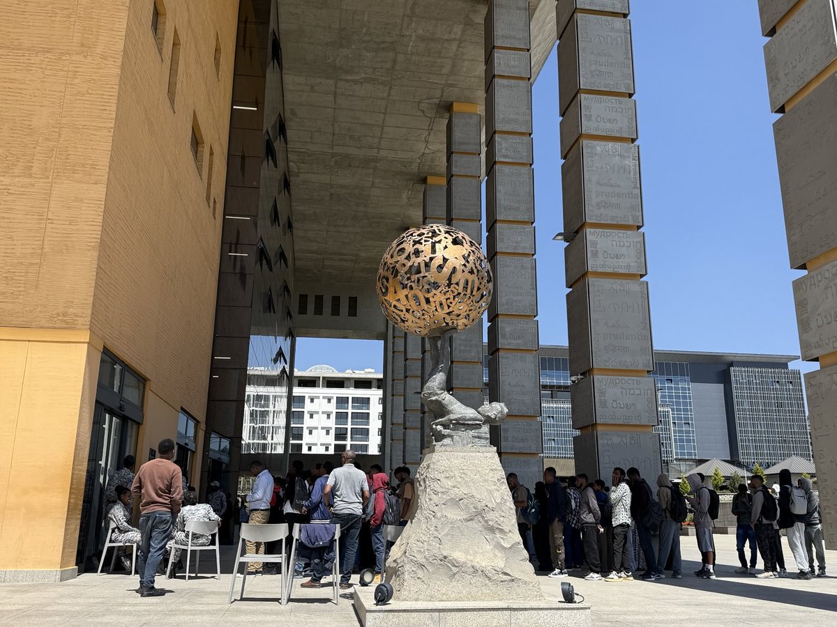 Young Ethiopians patiently queue at the iconic entrance of Abrehot Library in Addis Ababa, eager to step into a world of Knowledge and
Enlightenment.

Aberhote = Enlightenment