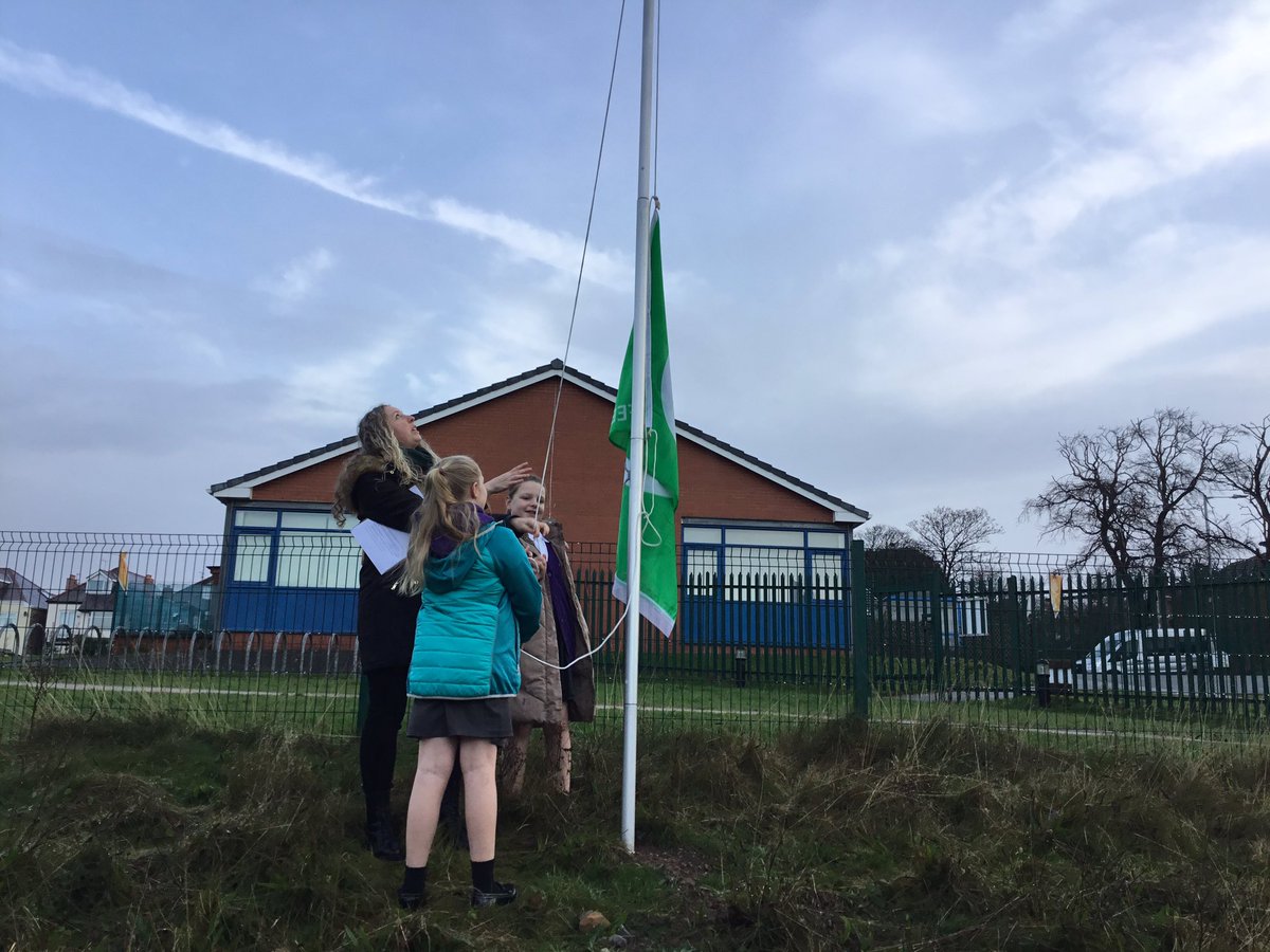 MountPSWallasey's tweet photo. Miss Kim and our fantastic Eco Committee were successful in the renewal of our Green Flag. Here they are raising it outside the school 🦔🍁 https://t.co/8npkXxyDJr