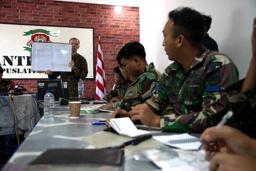 Precision U.S. Marine Corps Sgt. Bailey Mowry, a forward observer with Marine Rotational Force-Southeast Asia gives coordinates for a fixed-wing close air support simulation to Indonesian marines with 4th Marine Infantry Battalion, Pasmar 1, during Keris Marine Exercise 2023.