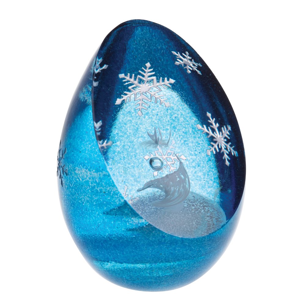 Marvel at the icy beauty of her frozen realm. The mythical Snow Queen twirls and spins within her frosted kingdom in this handcrafted glass artwork.