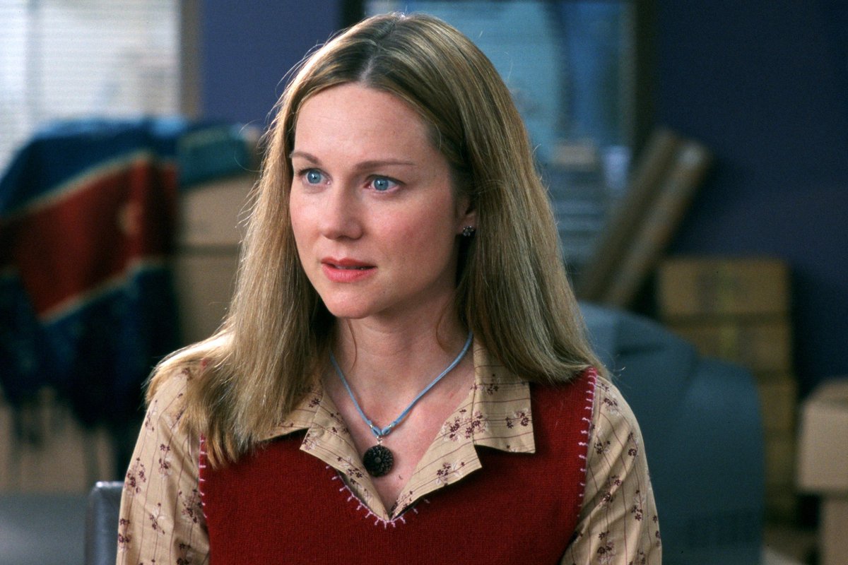 Laura Linney, plays Sarah, in Love Actually, with its message about selfless love. 
Sarah has had a crush on Karl in her office, for years. They eventually get together but their kissing is interrupted by one of the many phone calls from Sarah's psychiatric brother. Karl leaves.