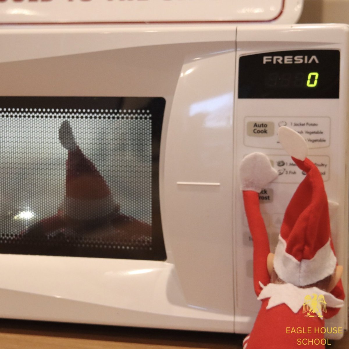 Day 8: After a late and cold night outside, Agnes is helping Ian defrost with a spin in the microwave. #eaglehouseschool #berkshireprepschool #prepschool #festivities #elfontheshelf #AI #SocialWonderland