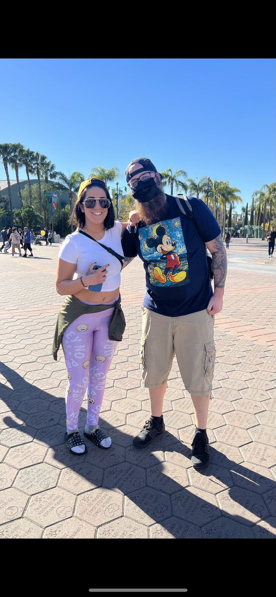 karleed11's tweet photo. @ImSteveMigs Listening to today’s 9am podcast where you talk about Seth Rollins saying he doesn’t get bothered at Disney. Now I feel bad for making Bayley take this photo with my husband there. 😂 She was super cool, though! https://t.co/eBL5kxmhAK