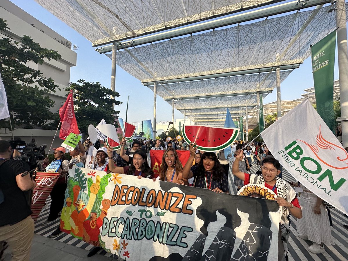 IBONIntlClimate's tweet photo. We're here at the Global Day of Action for Climate Justice at #COP28. Movements from all over the world demand an end to attacks against people and the planet.

We stand with the Palestinian people - there can be no climate justice on occupied land!

#Decolonize2Decarbonize https://t.co/jkYfepxT5F