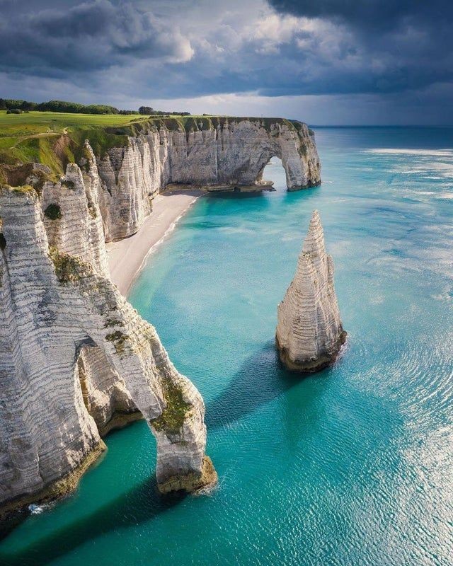 Exploring the beauty of Etretat, Spain: 'Nature's poetry is written on the cliffs, and every wave is a stanza.' 🌊📸 #EtretatAdventures #NatureQuotes #TravelInspiration
