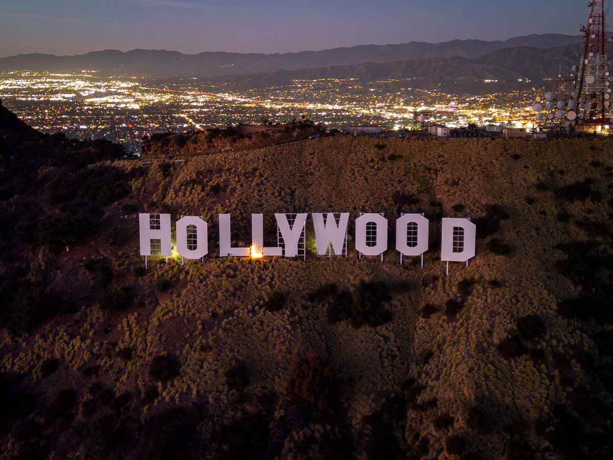 About last night… 💡🤔 Yesterday, Chairman Jeff Zarrinnam and Secretary Brian Lane ‘lit the Sign’ to commemorate the 100th anniversary of the first ever documented lighting of the Sign. For more history, visit HollywoodSign.org 📸 @birdmanphotos