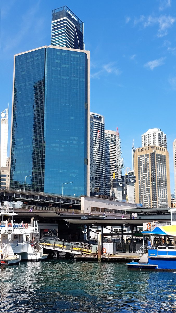The #Sydney city CBD high rise skyline behind the #CircularQuay ferry wharves on #SydneyCove #TravelOz #NewSouthWales #Australia