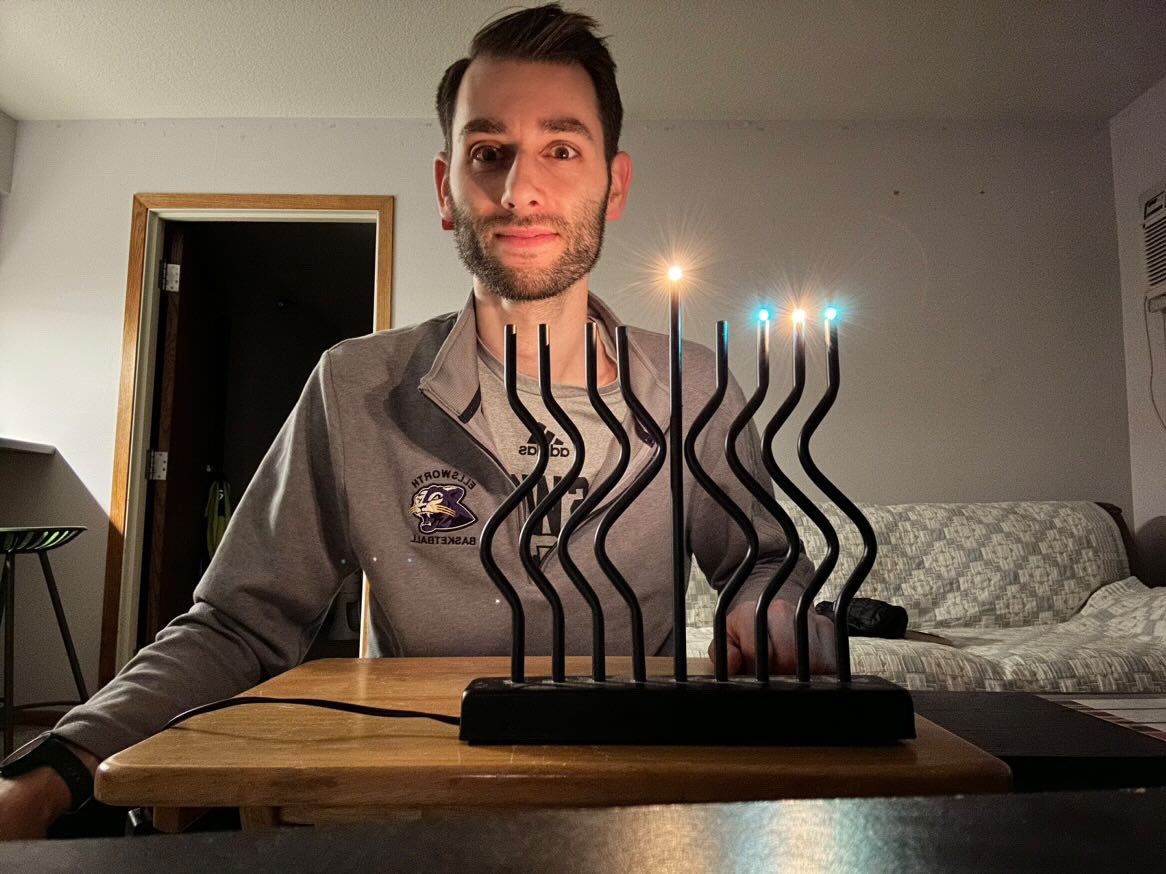 Ellsworth Men’s 🏀 assistant coach Ben Tanoff celebrating the 3rd night of Hanukkah. 🕎 @CoachTanoff 

#JCA | #CoachesLightCandles | #HappyHanukkah