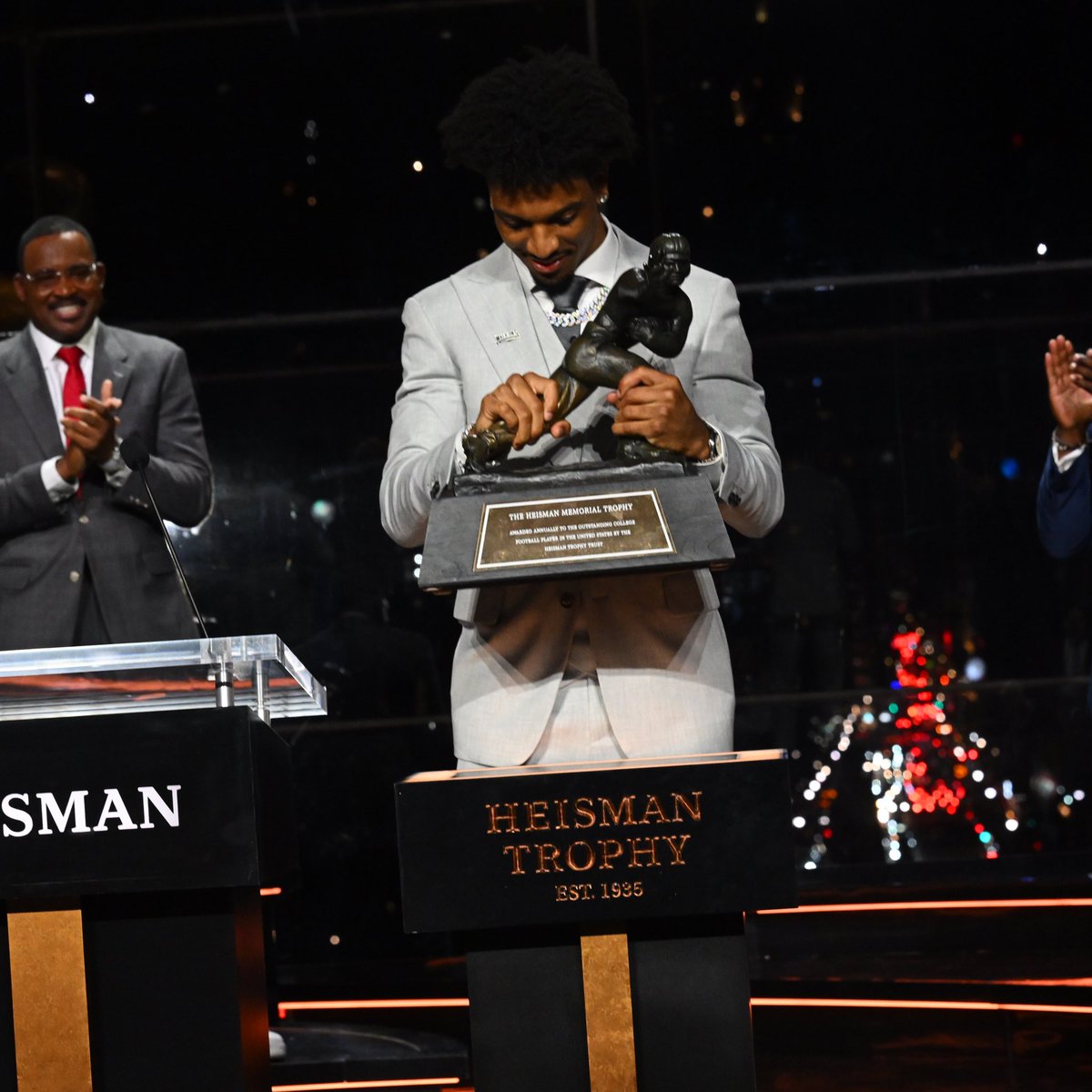 That Kid is holding more than a clipboard tonight. 

The Heisman Trophy Winner