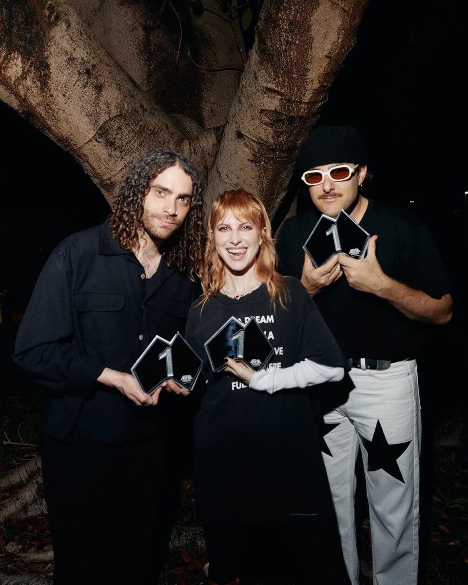 YELYAHPOI's tweet photo. new photo of paramore with their #1 album plaques for This Is Why, presented to them in Australia https://t.co/6rqj8nfanh