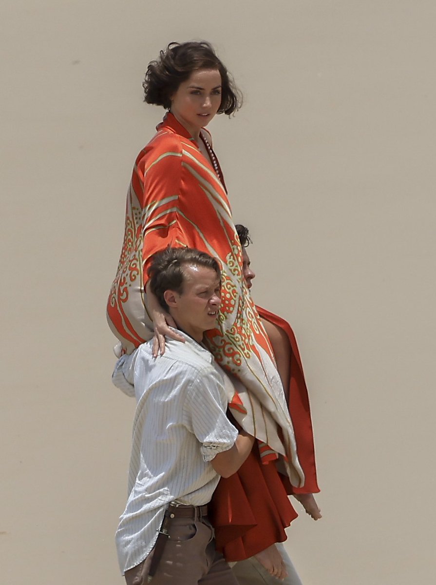 ana de armas being carried by two men on the set of her upcoming movie ...