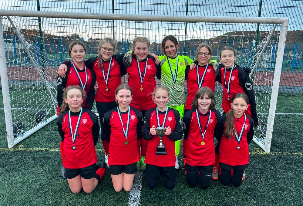 NHGS's tweet photo. Congratulations to the Y7 girls' football team who became County Cup Champions yesterday. They played a round-robin tournament at Leeds playing fields.  It was on a 3G pitch which they had not played on as a team before so the learning curve was steep but they coped admirably! https://t.co/69rQQ0U75T