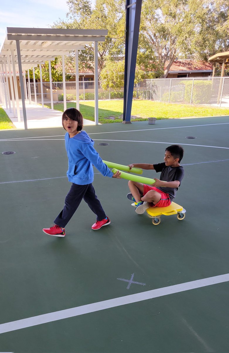 With our Holiday Themed Field Day quickly approaching, students @NPESharks are practicing the different activities to prepare. These students are practicing 'Sleigh Ride'. The Reindeer is pulling with pool noodles and the Elf is sitting on a scooter! 🦌🎅 @ccpsDRIVE2BFIT