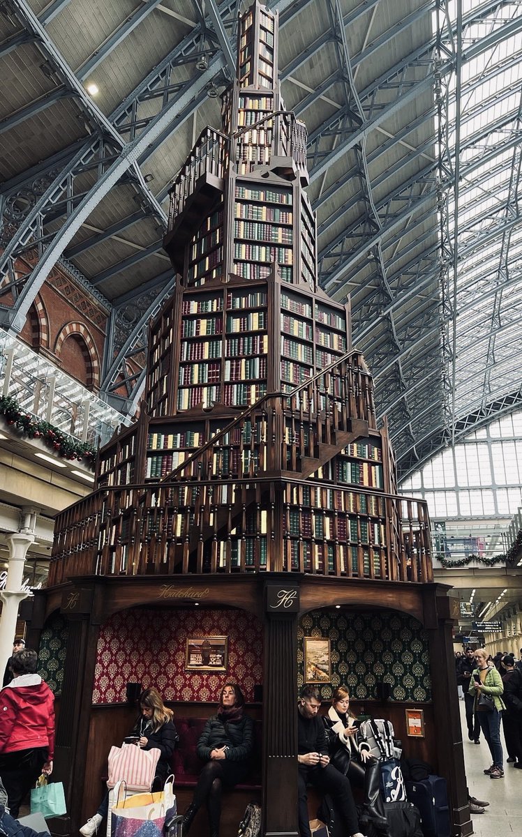 The Christmas book tree sponsored by Hatchards books at St. Pancras Station. The little booths at the bottom have speakers that read you a story while you wait for your train.