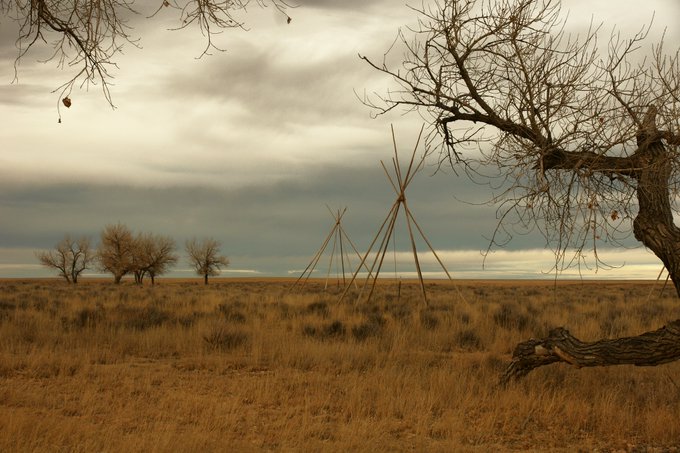 Lodge (Tipi) poles, arranged without the hide covering, are set up in the creek bed of the Big Sandy Creek, near where the Cheyenne and Arapaho people were encamped when the Sand Creek Massacre happened. 