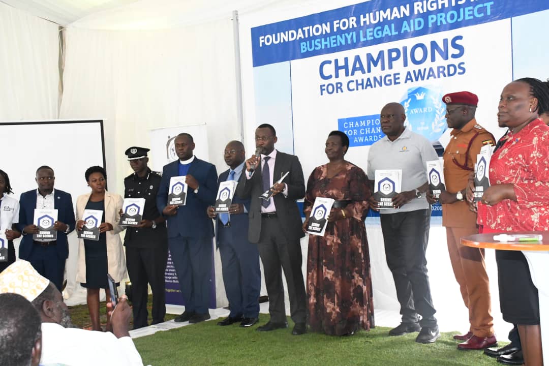 At the Champions Award Ceremony held at the FHRI Legal Aid Office, Bushenyi, His Lordship Amos Kwizera, the Resident Judge of Bushenyi launches the report'Behind the Scenes' which chronicles the progress made in Advancing Criminal Justice in Greater Bushenyi.