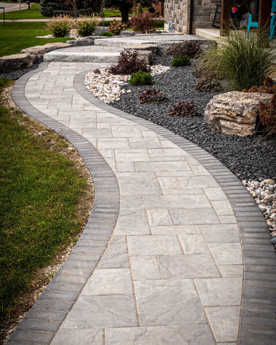 🌟 An absolutely picture-perfect walkway featuring Brown's Appian Pavers and Dimensional Steps. 🚶‍♂️✨ When you're ready to make your curb appeal skyrocket, we've got you covered! 🏡📈