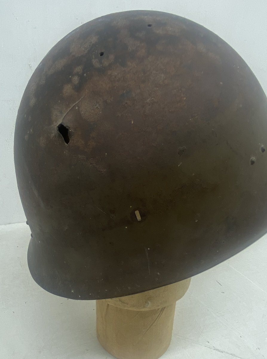 A grizzly reminder of the cost of war. This WW2 Japanese Type 90 combat helmet has a clean bullet entry point to one side, and a larger and ragged exit point to other. Almost certainly causing a fatal injury to its wearer. #JapaneseHelmet #WW2helmet @HansonsUK @HansonsAuctions