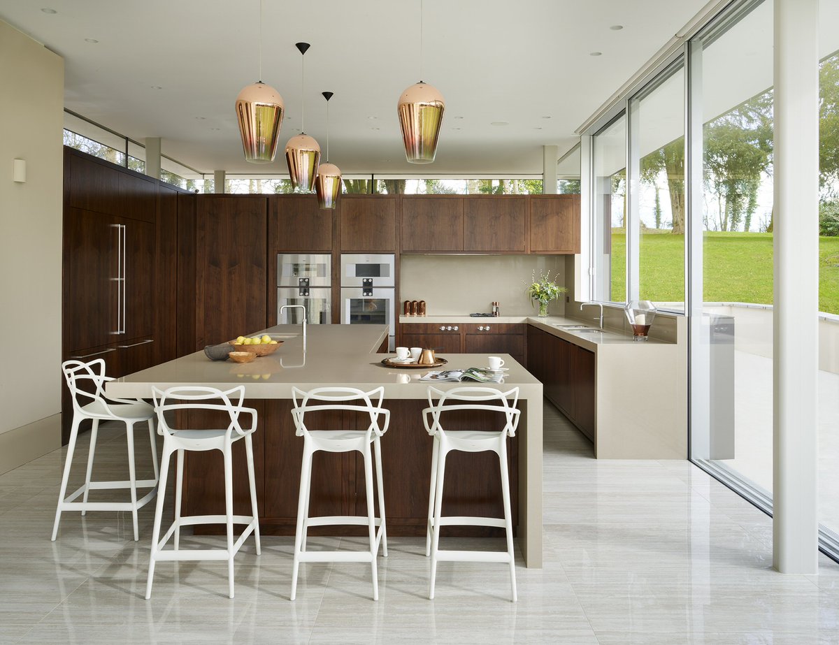 Project 5602.  Handleless stained walnut kitchen with secret door to Boot room beyond in this stunning contemporary addition to a classical Georgian rectory. Incorporating Gaggenau Appliances and 80mm countertops #kitchendesign #kitchendesignideas #kitchendesign