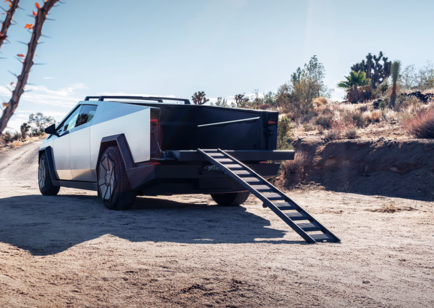 SawyerMerritt's tweet photo. BREAKING: 25 Cybertruck accessories are now available to view/order!

Highlights/Prices:
• Basecamp: $2,975
• Cybertruck color paint film (matte black or matte white): $6,500
• Cybertruck clear satin film: $5,000
• Tailgate ramp: $400
• Crossbar: $800
• Vault cargo divider: $350
• Cyber wheel cover: $75
• Snow chains: $345

Shop: https://t.co/T8kixd0kqP