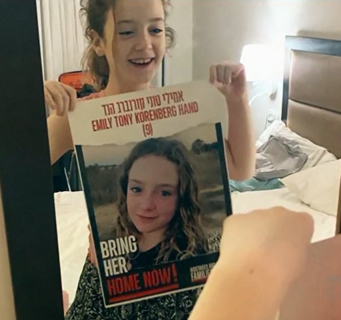 Emily holds up her own kidnapped poster. I hope every horrible person who tore down her poster sees this.