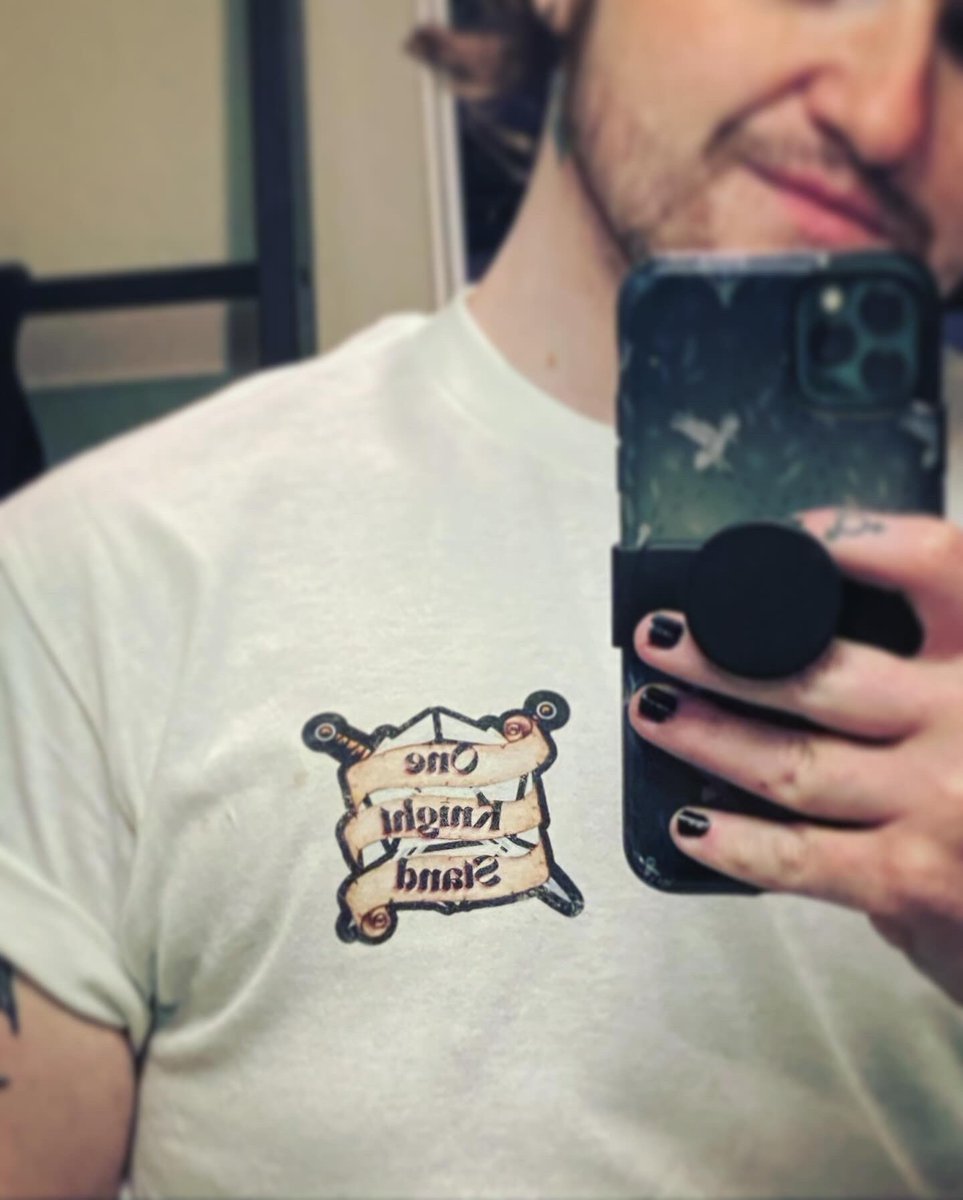 OKSstream's tweet photo. 🔥DID SOMEONE SAY MERCH?🔥
Check out a first run at a #OneKnightStandPod tee designed and made by @cuddlyryder! Stay tuned for a shirt giveaway soon on stream, and join our discord for more info on merch and other announcements!

(Discord and twitch linked below) https://t.co/5ElebCshHJ