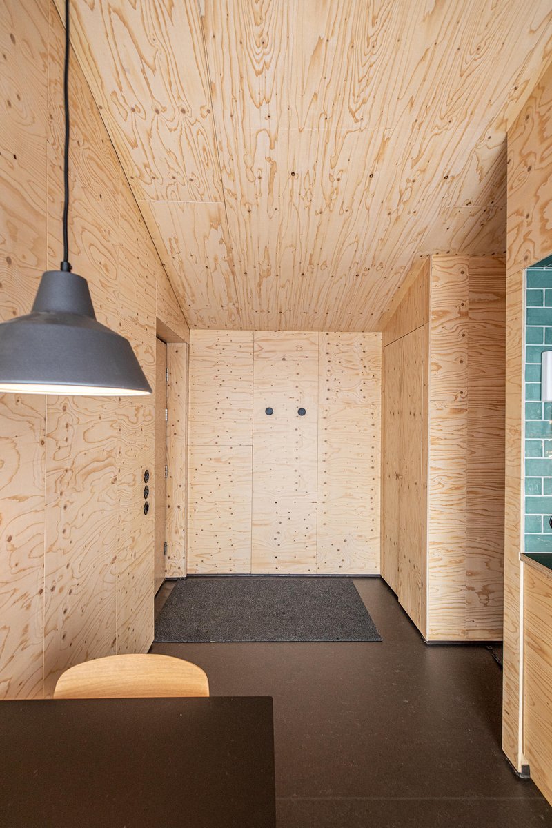 A 21 sqm #cabin features a double bedroom, private bath, and open-plan kitchen with a large window offering scenic views of Lake Mývatn and Hverfjall, creating a spacious and comfortable #interior with a small footprint. architonic.com/20198745
