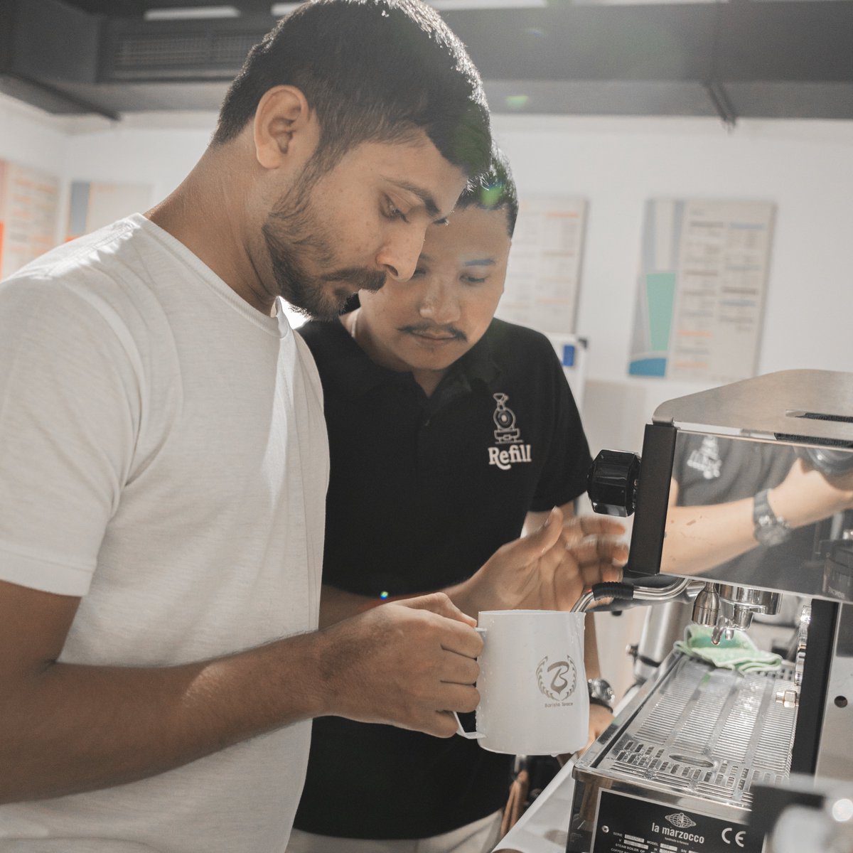 refillroastery's tweet photo. Steaming up the perfect cup! Ajit, our coffee sensei, sharing the art of milk steaming with a student. ☕✨ Curious to master the froth? Join us for a steamy adventure at Refill Coffee Roastery! #MilkMagic #BrewLikeAPro https://t.co/rggEZEmu5d