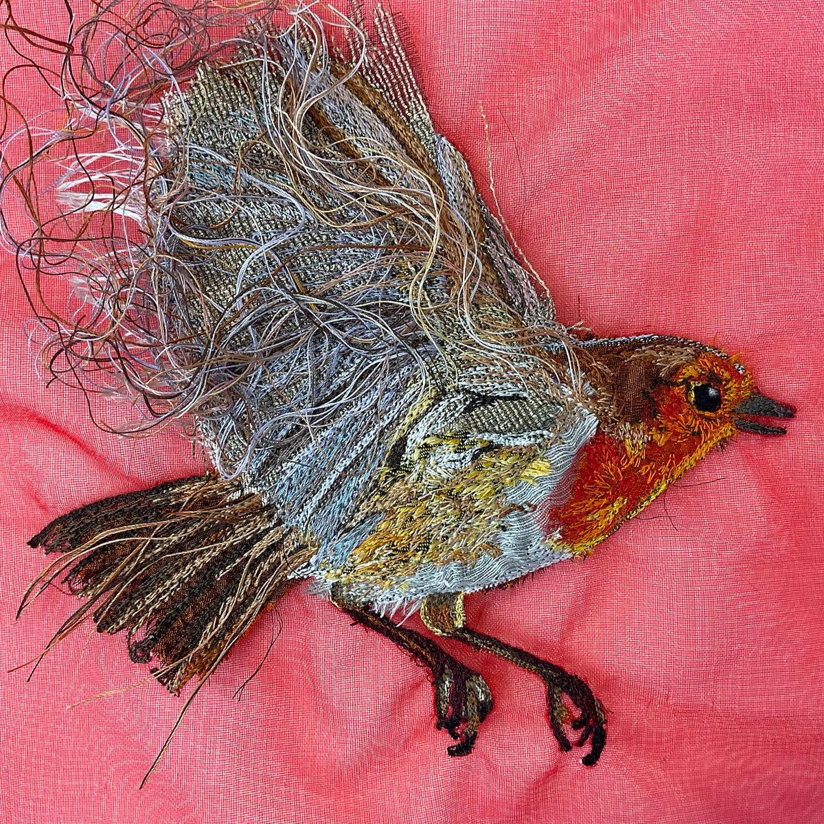 PootlesMoon's tweet photo. Here’s a little #festive #robin for the first day of the month and for my (belated 🤦🏼‍♀️) November challenge for @aurifil. He’s sewn with 40 and 50w threads onto an organza background, various sparkly appliqué pieces and of course my customary tangle of threads! #bird #embroidery https://t.co/2tA2G2d46I
