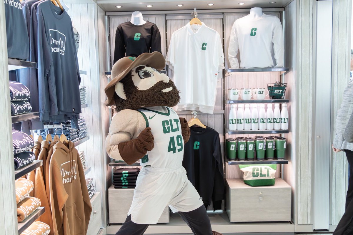 rmikehill's tweet photo. A huge moment for Niner Nation as alumni-owned @704Shop opened in @CLTAirport. And look at @Dlaw10_ with her front-and-center NIL pose! Thanks @PLshopdinefly and @49ersLicensing for putting our brand in front of millions of travelers including 85K local alumni! #GoldStandard⛏️ https://t.co/QZIBOdzicU