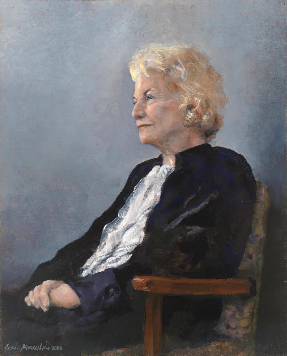 Seated portrait of a woman in side left profile. She wears jurors robes and her hands at clasped in her lap.