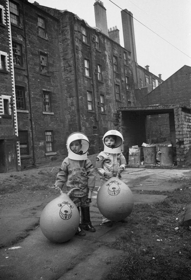 The Ghosts of Christmas past #AdventCalendar - Day 1.
.
Two kids show off their Christmas presents, Crown Street, Gorbals, Glasgow, December 1970.
Photo TSPL
